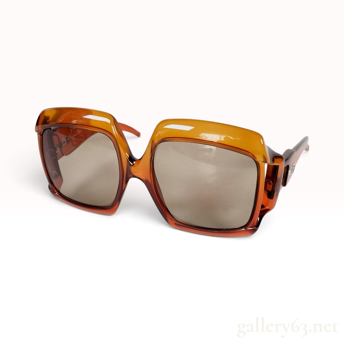 Vintage Christian Dior 2007 Amber Translucent Optyl Sunglasses: This pair of Christian Dior sunglasses is crafted from translucent amber Optyl. The oversized frames feature a square silhouette with distinctive cut-out bridge details and thick temples. Each exterio