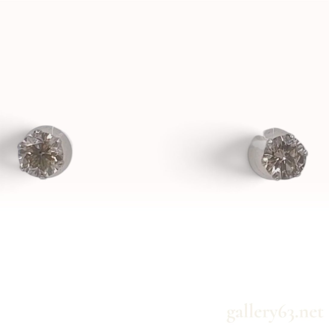 Alisa Pt900 0.70ctw Natural Diamond Stud Earrings with Box: A matched pair of Alisa stud earrings crafted from Pt900 platinum and 0.70ctw natural diamonds. Each earring features a round brilliant-cut natural diamond held in a six-prong basket setting. The diam