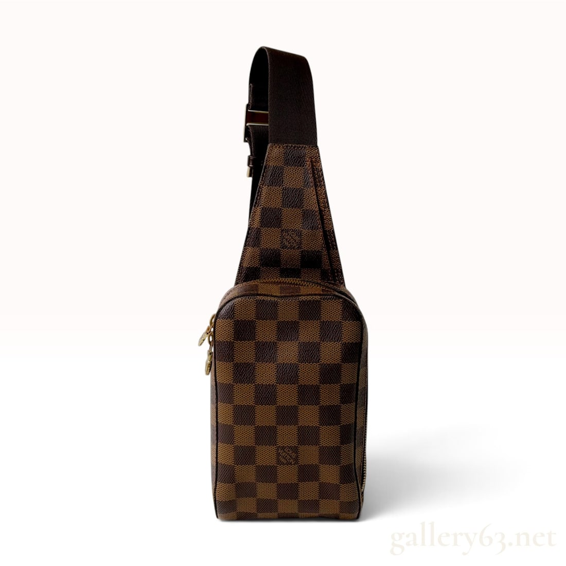 Louis Vuitton Damier Ebene Geronimos Sling Bag: This Louis Vuitton Geronimos sling bag is crafted from Damier Ebene coated canvas with dark brown leather trim and an adjustable brown textile strap. The functional design includes a main zippered com