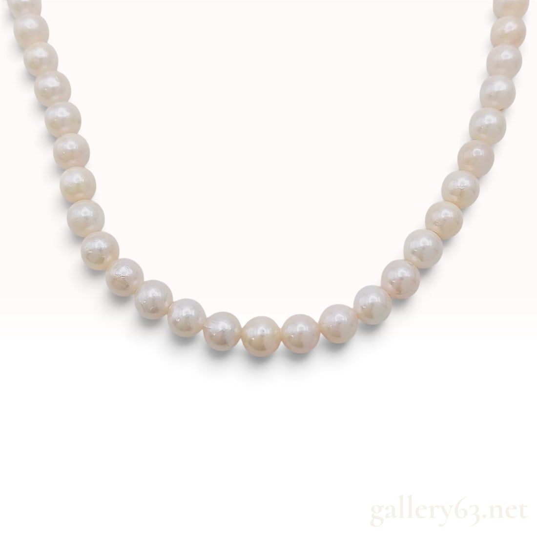 Vintage Silver and 6mm to 6.5mm Cultured Pearl Knotted Strand Necklace: This vintage single-strand cultured pearl necklace is hand-knotted on white silk thread. The strand consists of semi-uniform pearls measuring approximately 6mm to 6.5mm in diameter. The pearls display