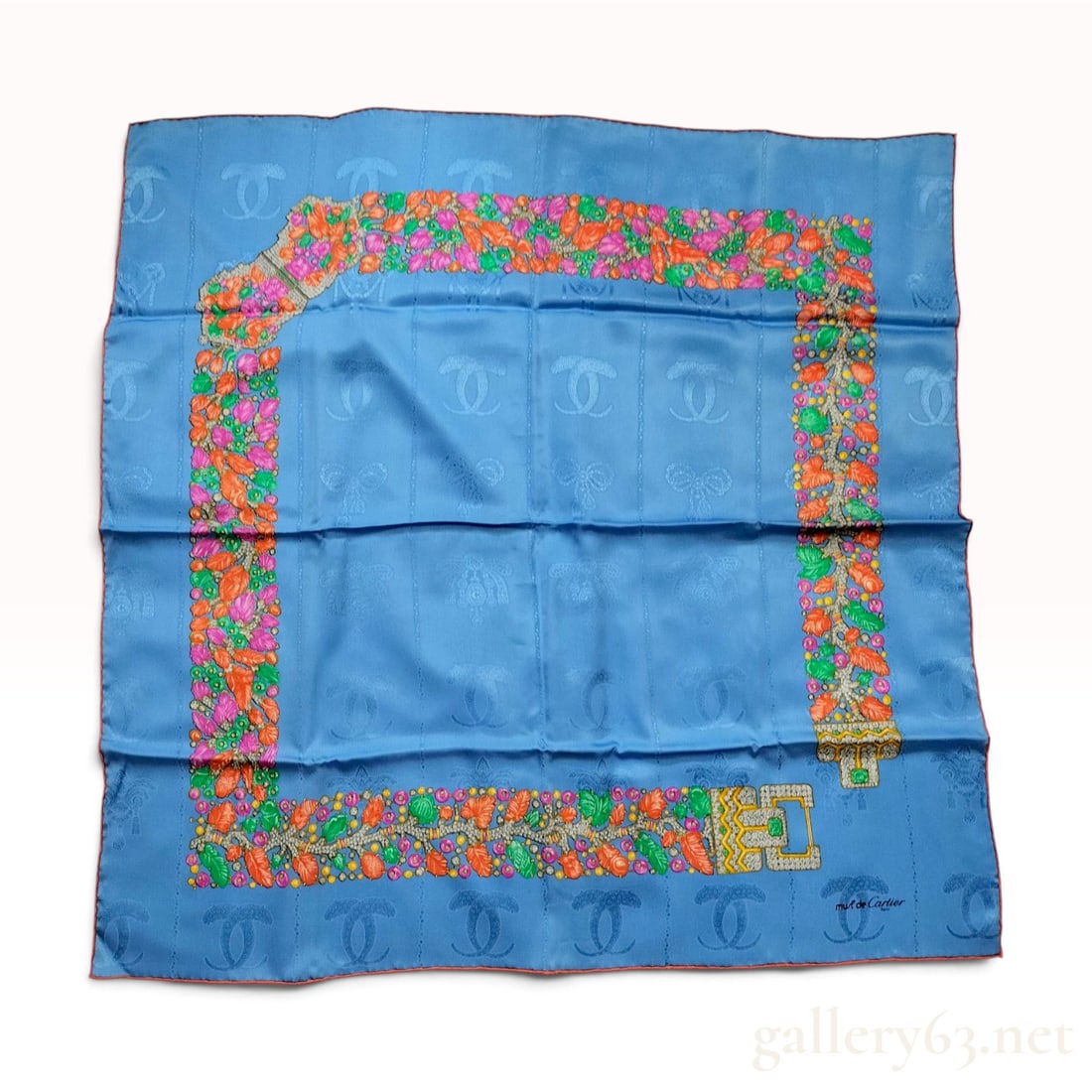 Vintage Must de Cartier Tutti Frutti Jeweled Blue Silk Carre 90 with Box: A vintage Must de Cartier silk carre 90 crafted from a sky-blue silk jacquard featuring a woven tone-on-tone pattern of repeating interlocking C logos and jeweled bow motifs. The printed design showca