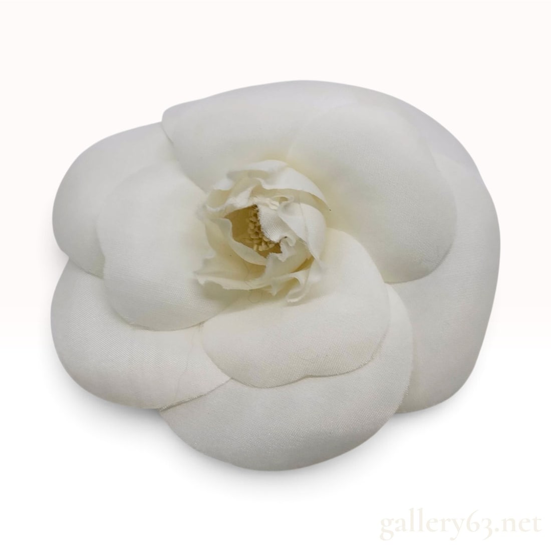 Vintage Chanel Camellia White Fabric Brooch with Box: This Chanel camellia brooch is crafted from white satin-textured fabric featuring a multi-layered petal design. The construction consists of overlapping, rounded petals radiating from a central bud. T