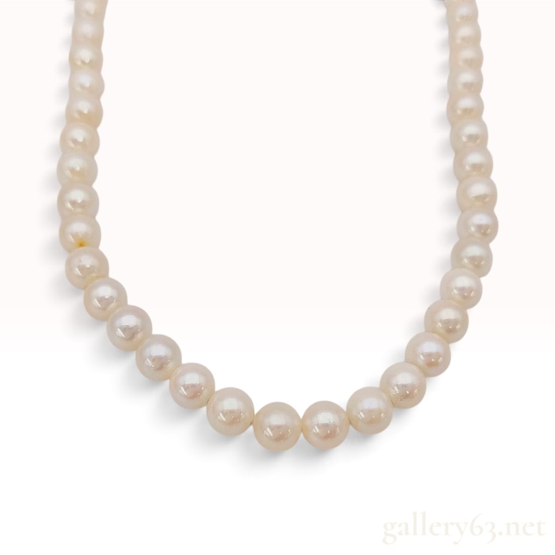 Silver and 6.0mm-6.5mm Cultured Pearl Hand-Knotted Choker Necklace: This is a hand-knotted single strand of cultured pearls featuring approximately 58 pearls measuring between 6.0mm and 6.5mm in diameter. The pearls display a creamy white body color with soft pinkish 
