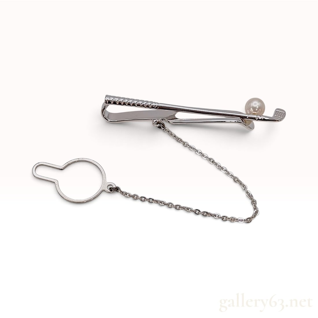 Vintage Mikimoto Sterling Silver and 5.5mm Pearl Golf Club Tie Bar: This Mikimoto tie bar is crafted from sterling silver in a figural design shaped like a golf club. The piece features a textured grip on the handle and fine incised lines on the club head. A single 5.