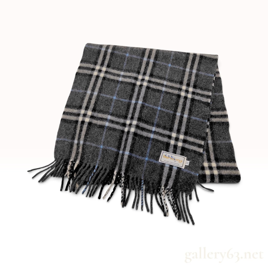 Vintage Burberrys Check Charcoal Gray Pure Cashmere Scarf: This Burberrys scarf is crafted from 100% pure cashmere featuring a classic check pattern in tones of charcoal gray, black, off-white, and light blue. The design is finished with twisted fringe along 