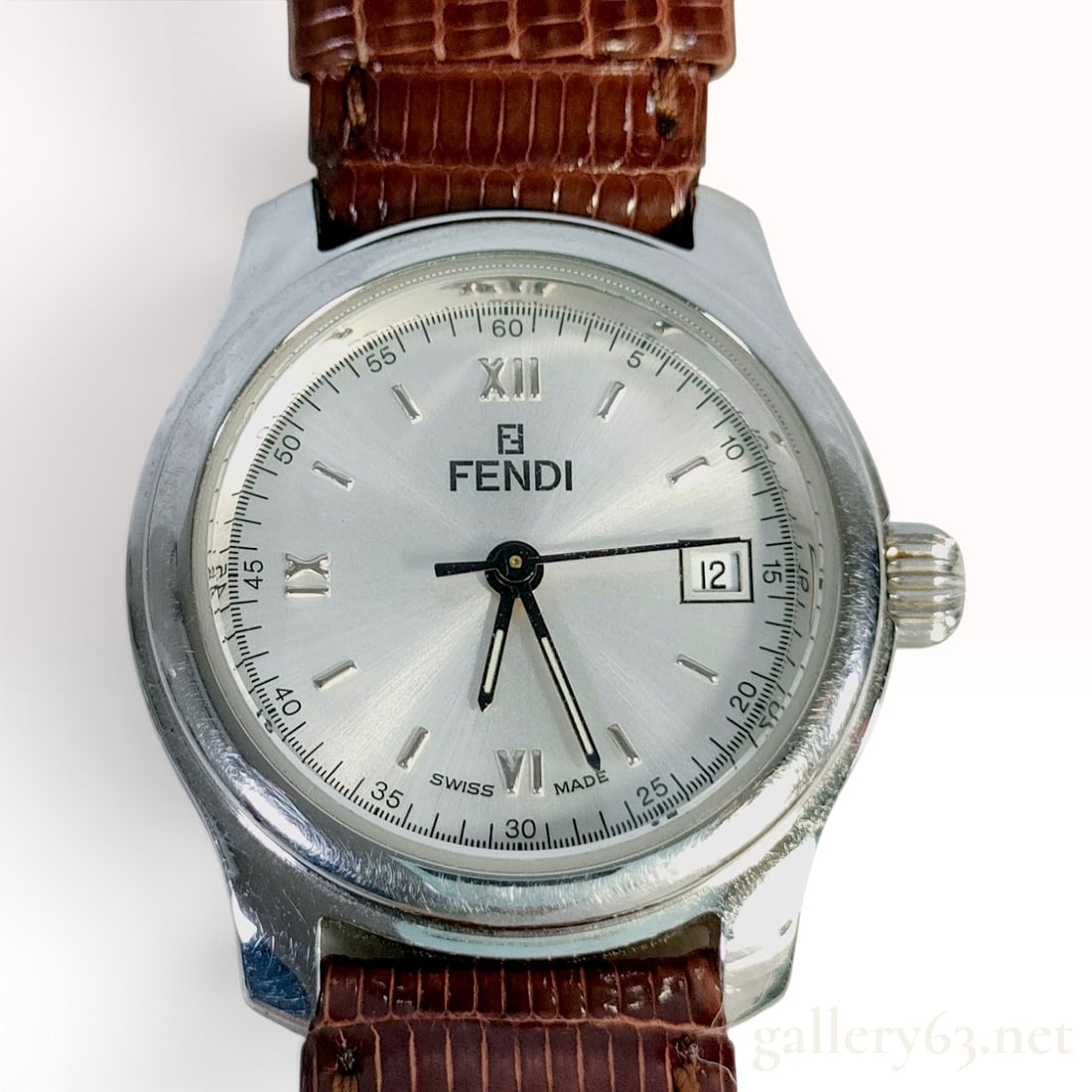 Fendi Orologi 210L Stainless Steel Date Wristwatch With Brown Leather Strap 25.8mm: This Fendi Orologi 210L wristwatch features a stainless steel case and a silver sunburst dial. The dial displays applied silver-toned Roman numerals at the twelve, six, and nine o'clock positions, com