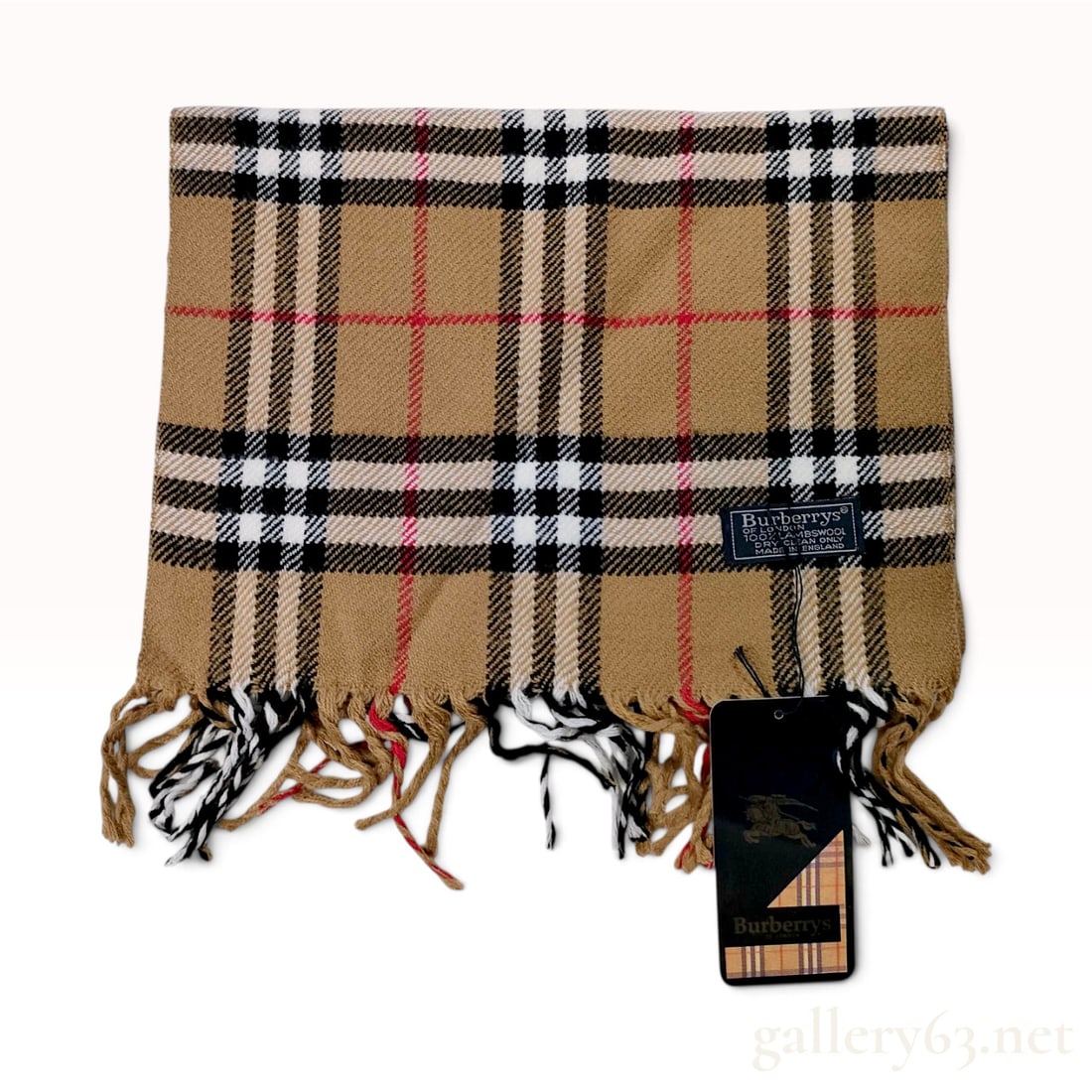Vintage Burberrys Classic Nova Check Tan Lambswool Scarf NWT: This is a vintage Burberrys scarf crafted in England from 100% lambswool. The design features the iconic house check pattern consisting of a camel-tan base overlaid with black and white stripes and th