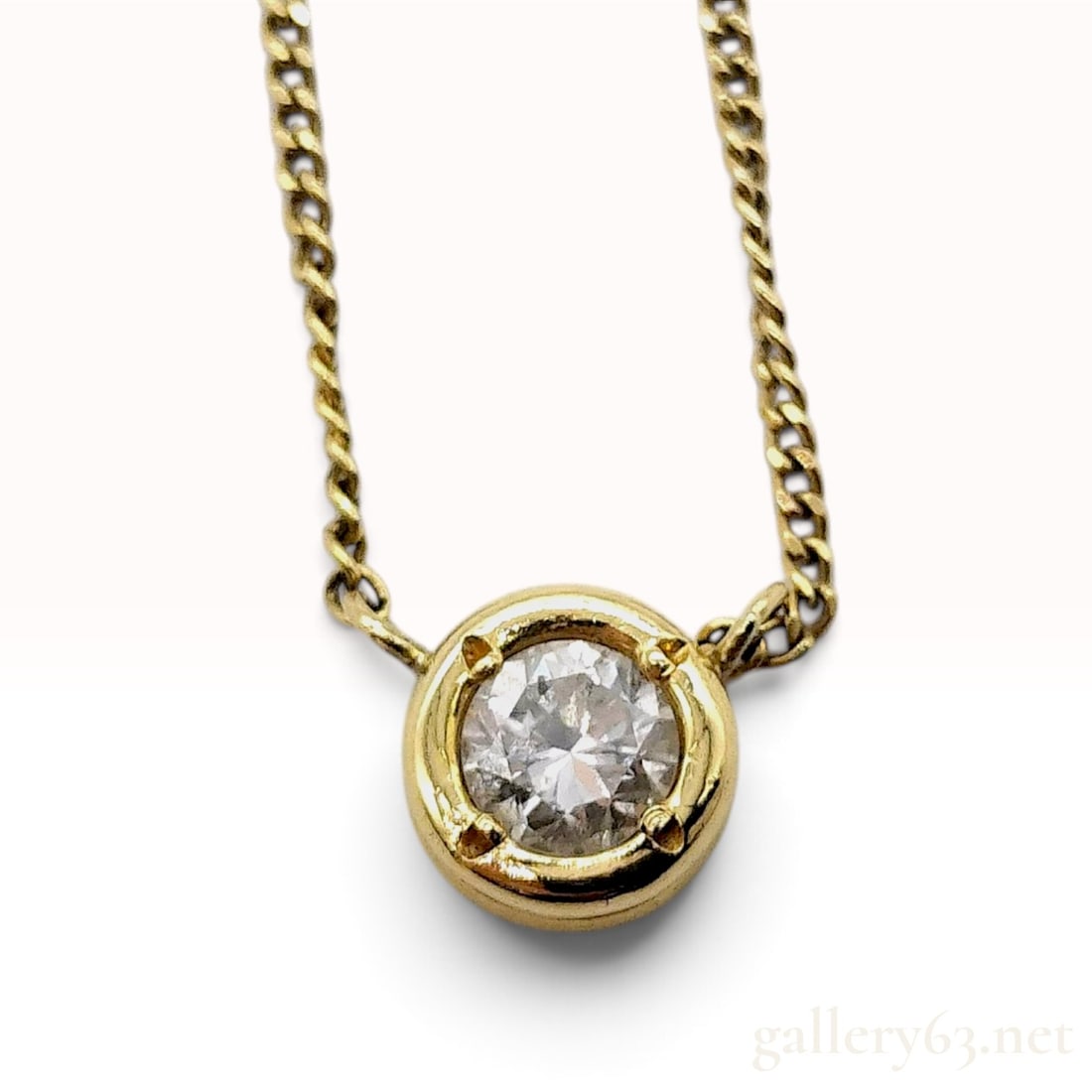 18K Yellow Gold and 0.29ct Natural Diamond Solitaire Pendant Necklace: This is an 18 karat yellow gold pendant necklace featuring a single round brilliant-cut natural diamond. The diamond is bezel-set within a circular mounting accented with four decorative prongs at the