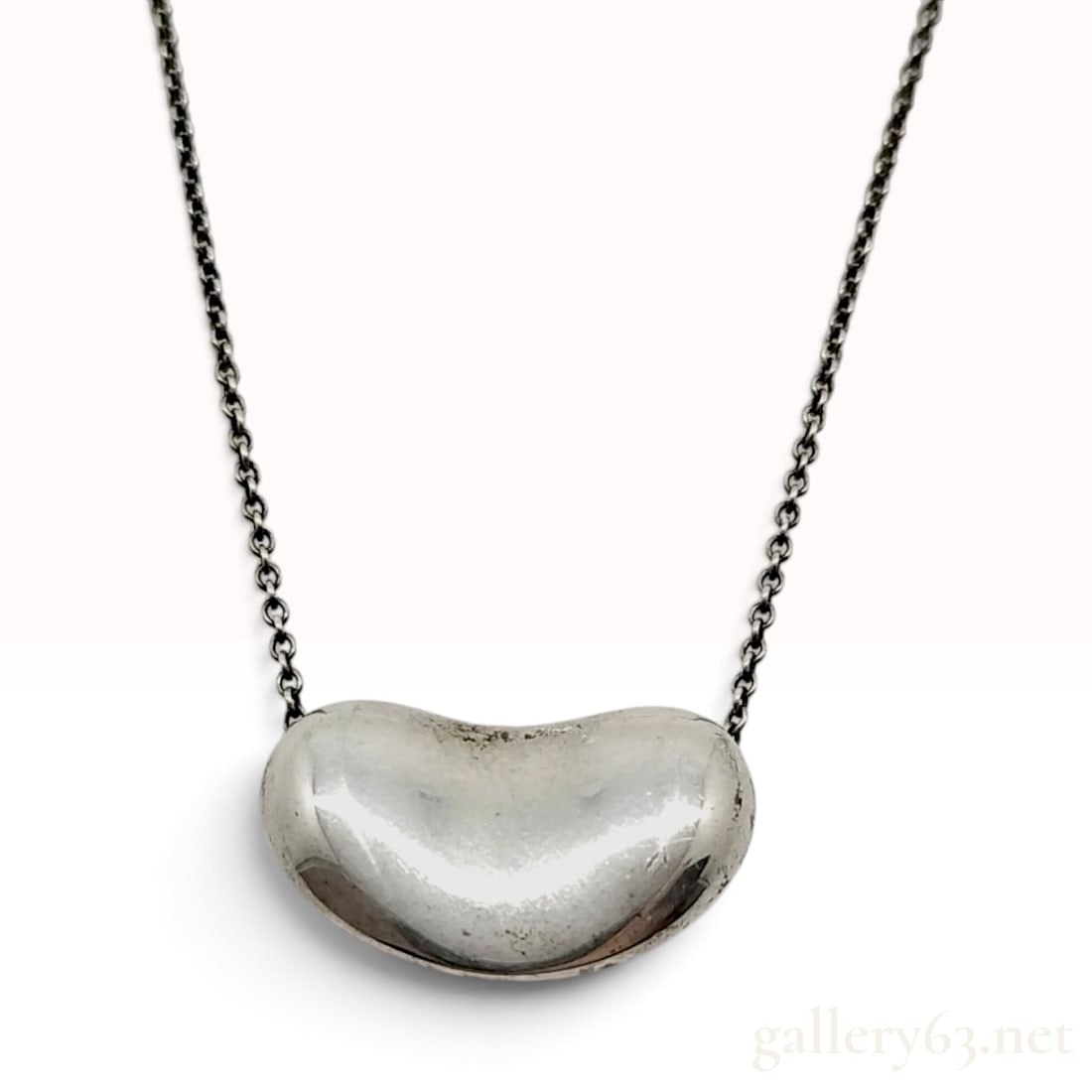 Vintage Tiffany & Co. Elsa Peretti Bean Sterling Silver Pendant Necklace: This Tiffany & Co. pendant necklace features the iconic Bean motif designed by Elsa Peretti. The piece is crafted from sterling silver and consists of a smooth, organic three-dimensional bean pendant 