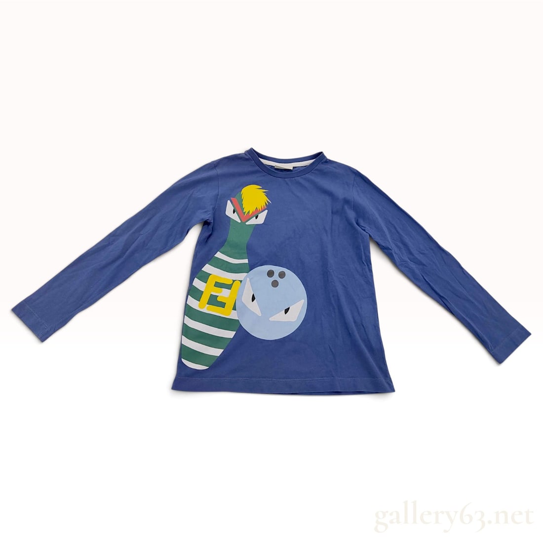 Fendi Kids Bugs Bowling Graphic Blue Cotton Long-Sleeve T-Shirt: This Fendi Kids long-sleeve t-shirt is crafted from a medium blue cotton jersey. The front features a large graphic motif depicting a green and white striped bowling pin and a light blue bowling ball.