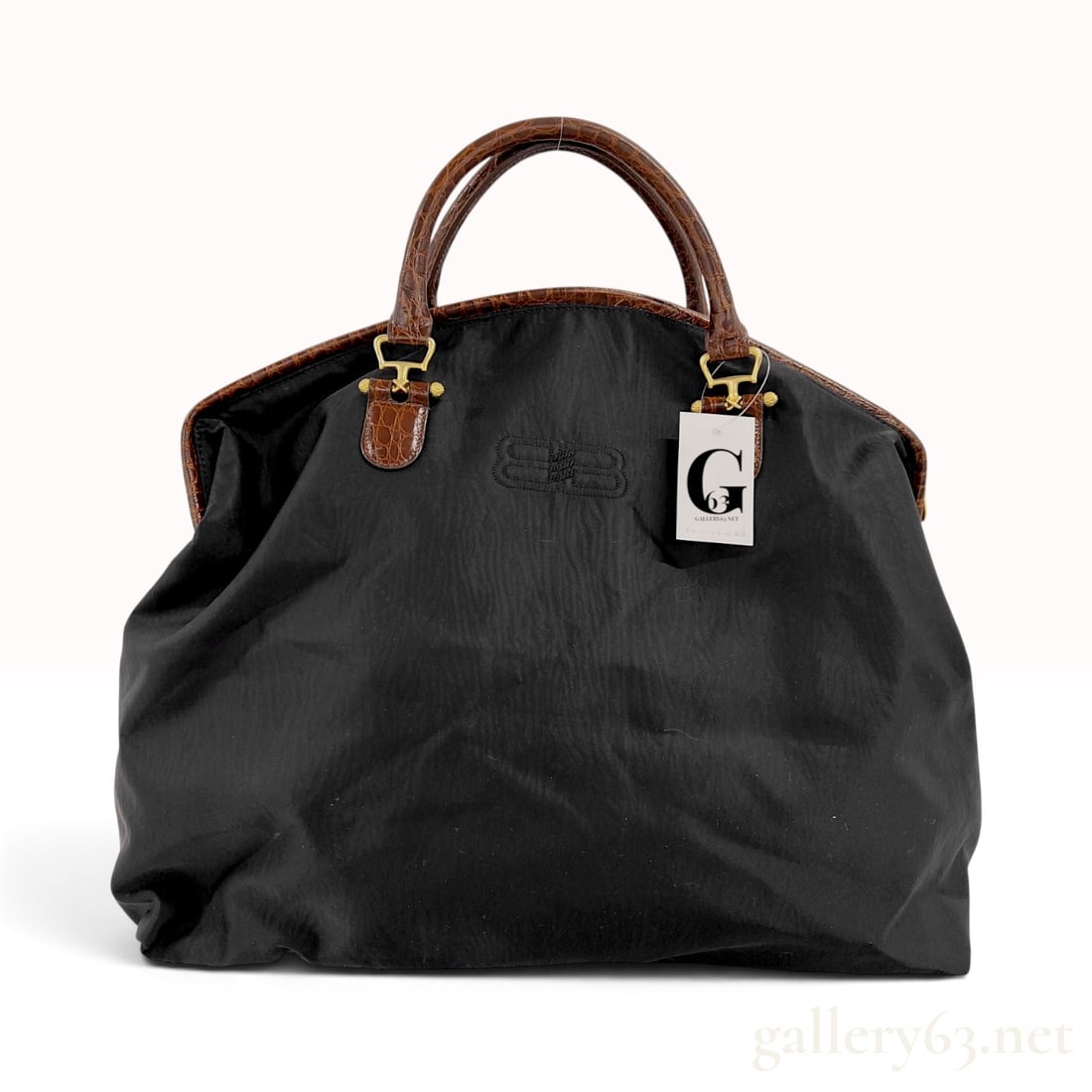 Vintage Balenciaga Black Nylon and Crocodile-Embossed Leather Boston Travel Bag: This Balenciaga travel bag is crafted from a slouchy black textile body accented with brown crocodile-embossed leather handles and trim. The front of the bag features a tonal embroidered logo of two i
