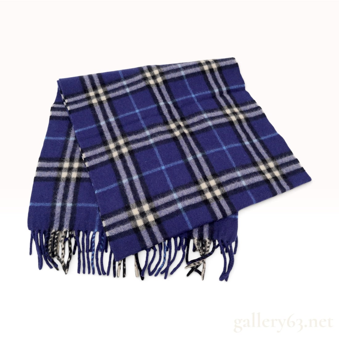 Vintage Burberrys Check Navy Blue and Purple Pure Cashmere Scarf: This Burberrys scarf is crafted from 100% pure cashmere in a signature check pattern featuring a deep navy blue and purple ground with intersecting stripes of black, cream, and light blue. The rectang