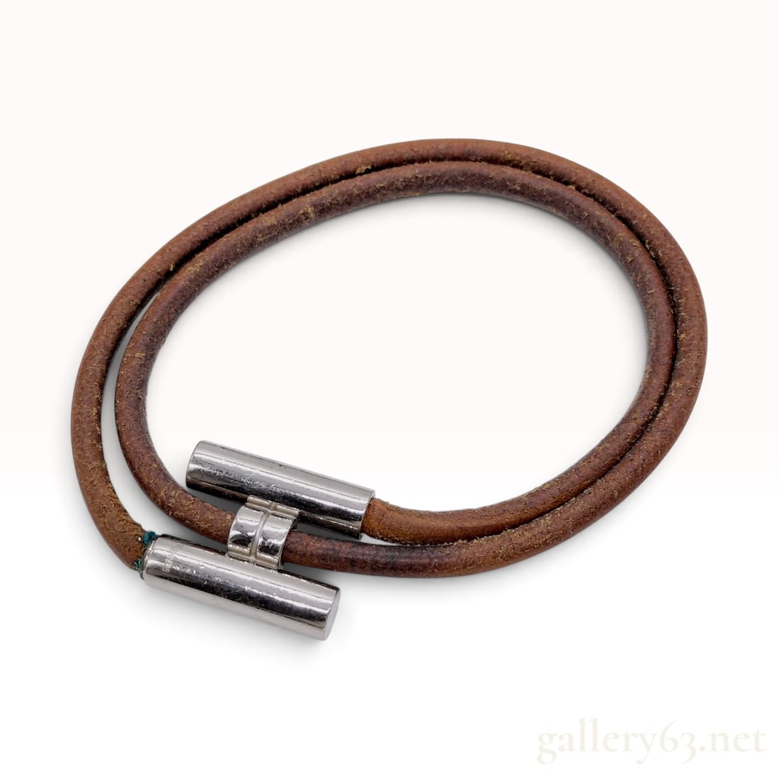 Vintage Hermes Tourni Tresse Brown Leather Double Wrap Bracelet with Box: This Hermes Tourni Tresse bracelet is crafted from brown leather cord and silver-tone metal hardware. The design features a double-wrap cord construction secured by a toggle clasp with a central loop 