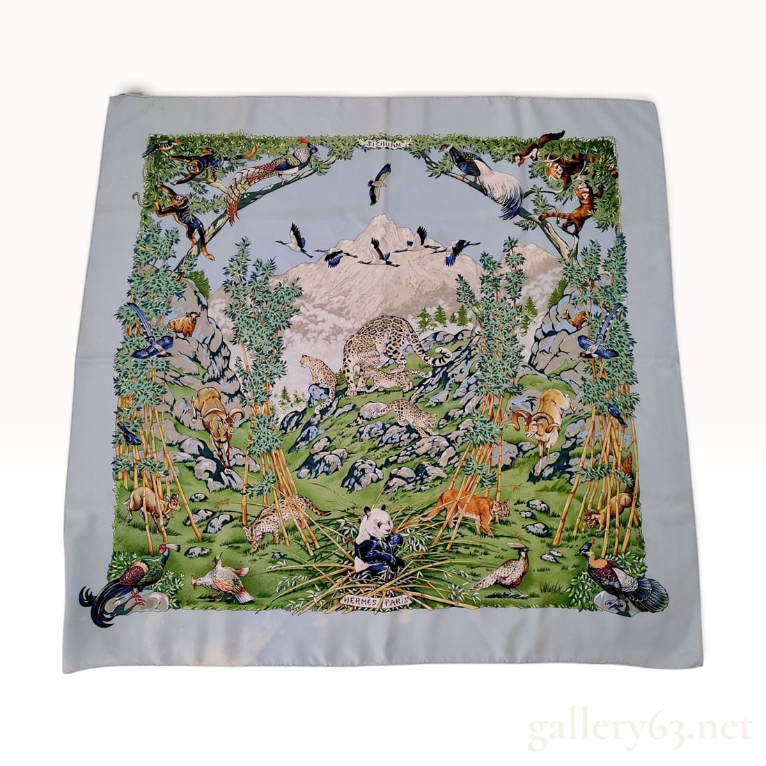 Vintage Hermes Sichuan Light Blue Silk Carre 90: This Hermes silk carre 90 is crafted from 100% silk twill featuring the Sichuan pattern designed by Robert Dallet. The intricate wildlife illustration depicts the diverse flora and fauna of the Sichua