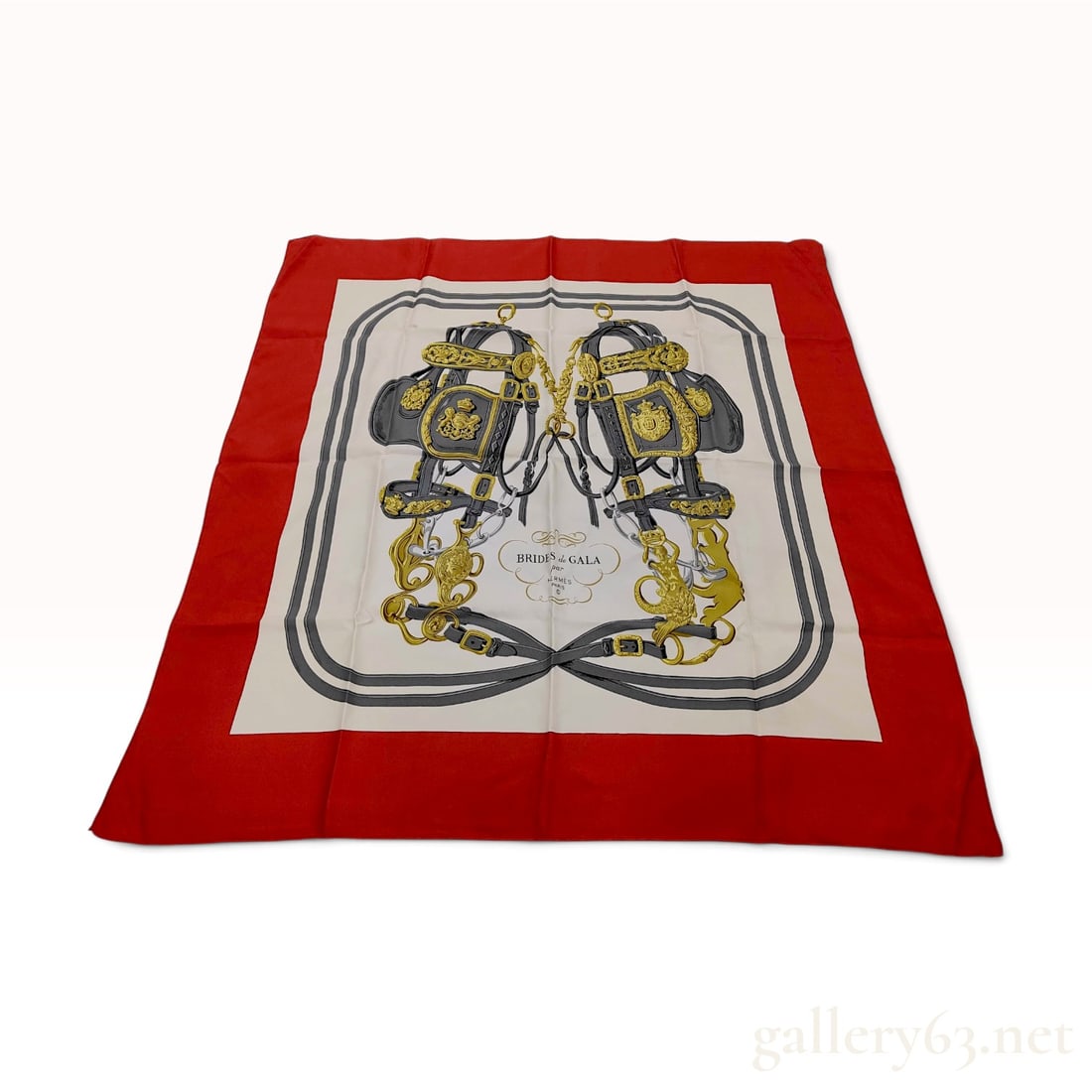Vintage Hermes Brides de Gala Red and Cream Silk Carre 90: This Hermes silk carre 90 is crafted from 100% silk twill in the Brides de Gala pattern designed by Hugo Grygkar. The composition features two highly ornate equestrian bridles rendered in shades of gr