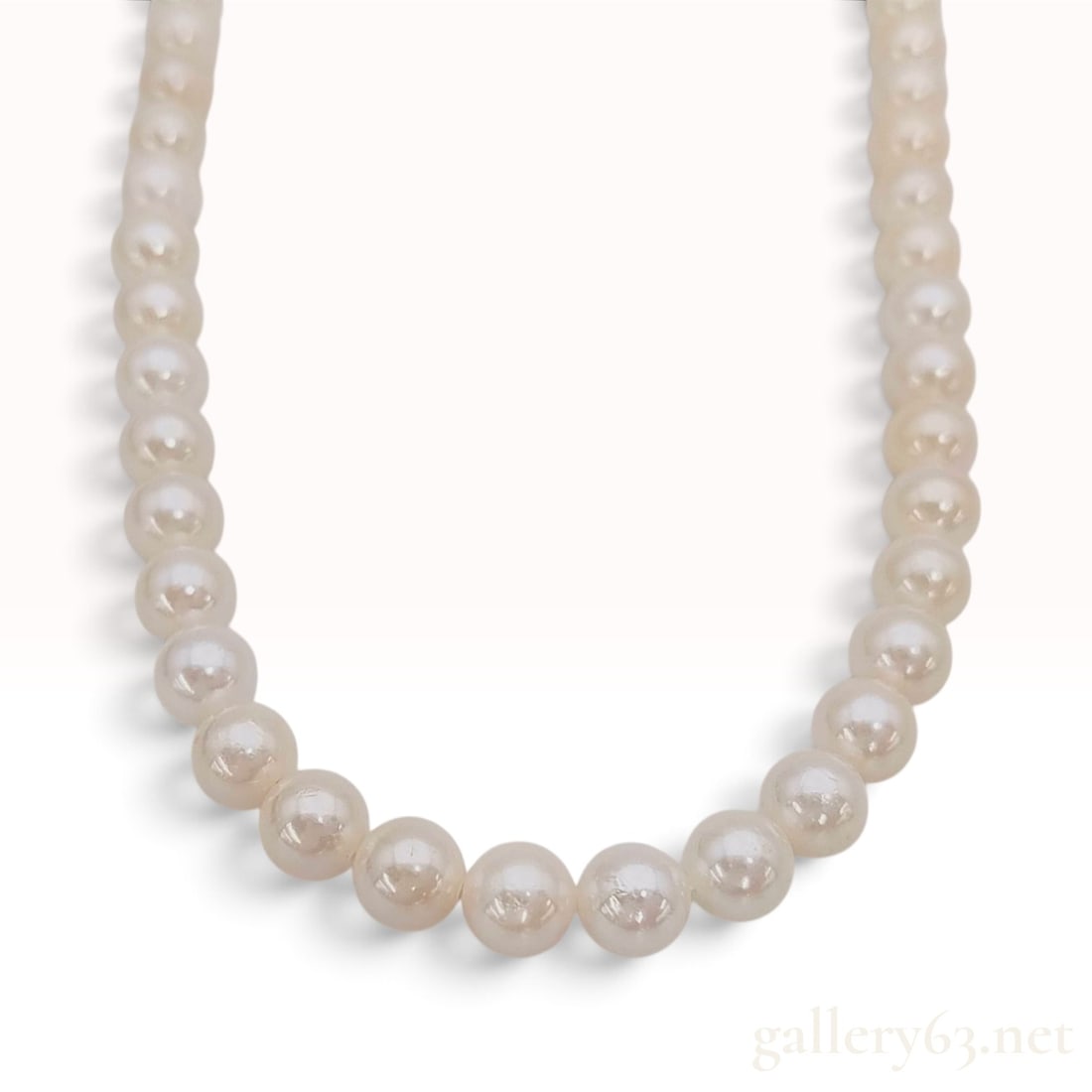 Silver and White Cultured Pearl Single Strand Necklace 35cm: This single-strand necklace is crafted from silver and cultured pearls. The strand features individually knotted cultured pearls measuring approximately 6.0mm to 6.5mm in diameter. The pearls display 