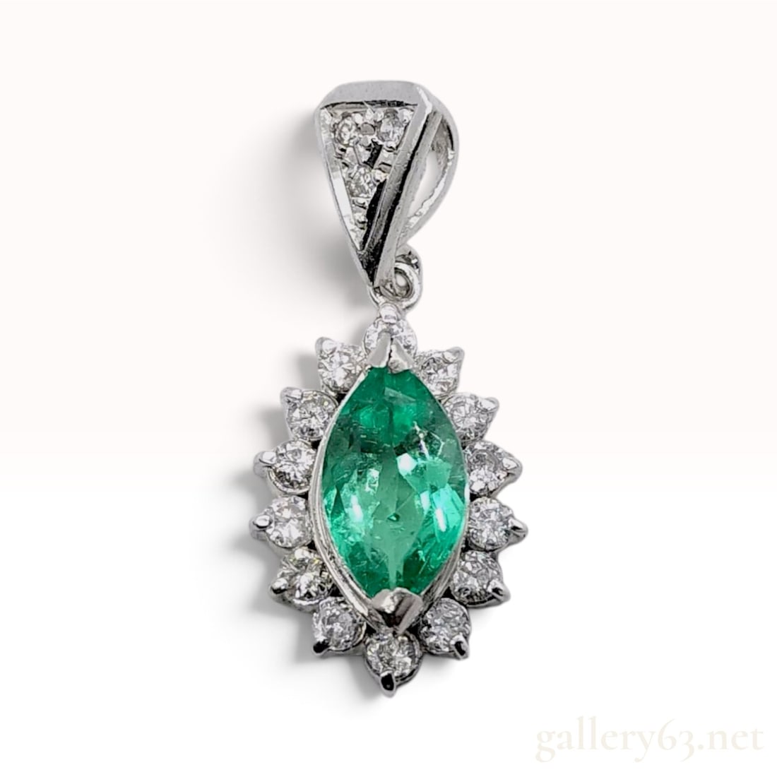 Pt900 0.79ct Natural Emerald and 0.34ctw Natural Diamond Halo Pendant: This pendant is crafted from Pt900 platinum and features a central marquise-cut natural emerald. The emerald displays a vibrant green color with characteristic natural internal inclusions. It is borde