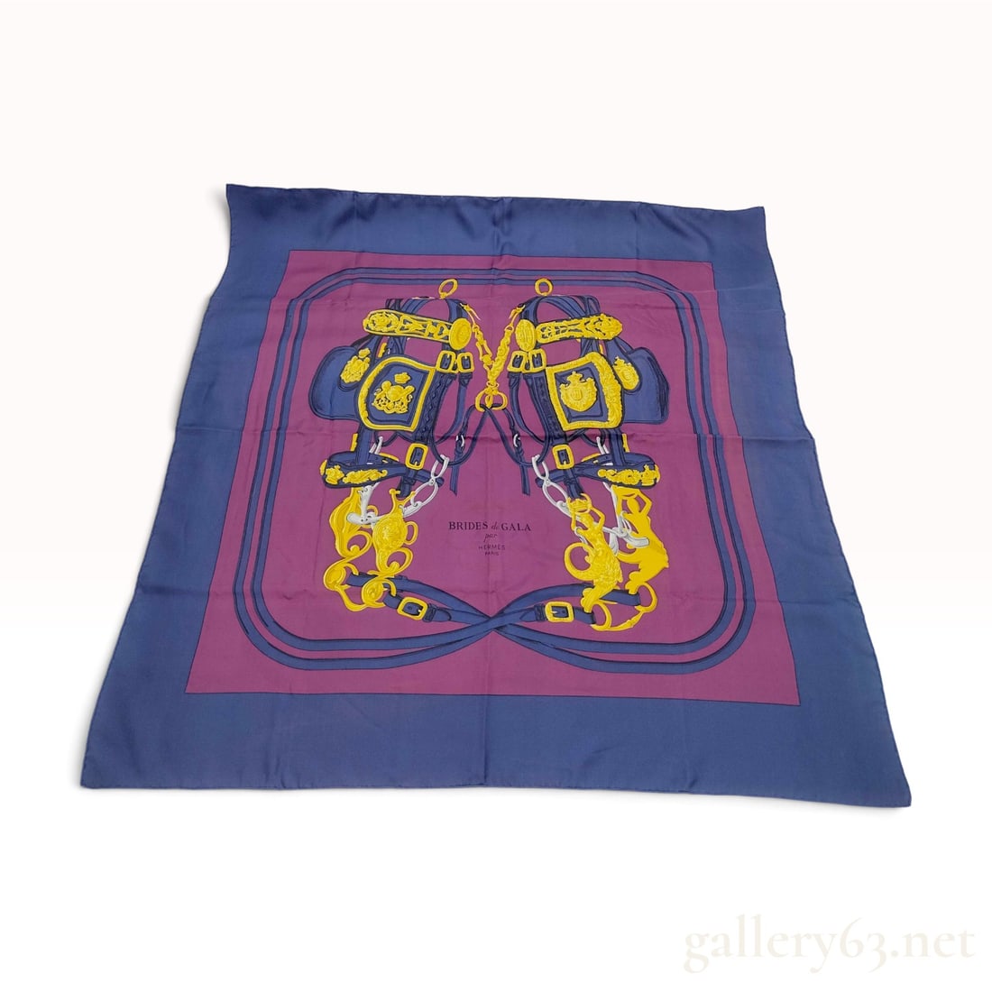 Vintage Hermes Brides de Gala Navy and Magenta Silk Carre 90 with Box: This Hermes silk carre 90 is crafted from silk twill in the Brides de Gala pattern, featuring a navy blue border surrounding a magenta central field. The design depicts two ornate gala bridles arrange