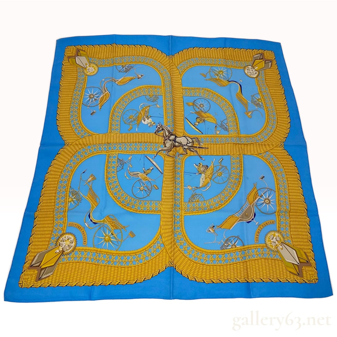 Vintage Hermes Voitures Paniers Blue and Gold Silk Carre 90: This is a Hermes silk carre 90 in the Voitures Paniers (Basket Carriages) pattern designed by Julia Abadie. The design features a central leaping gray horse framed by four vignettes depicting various 