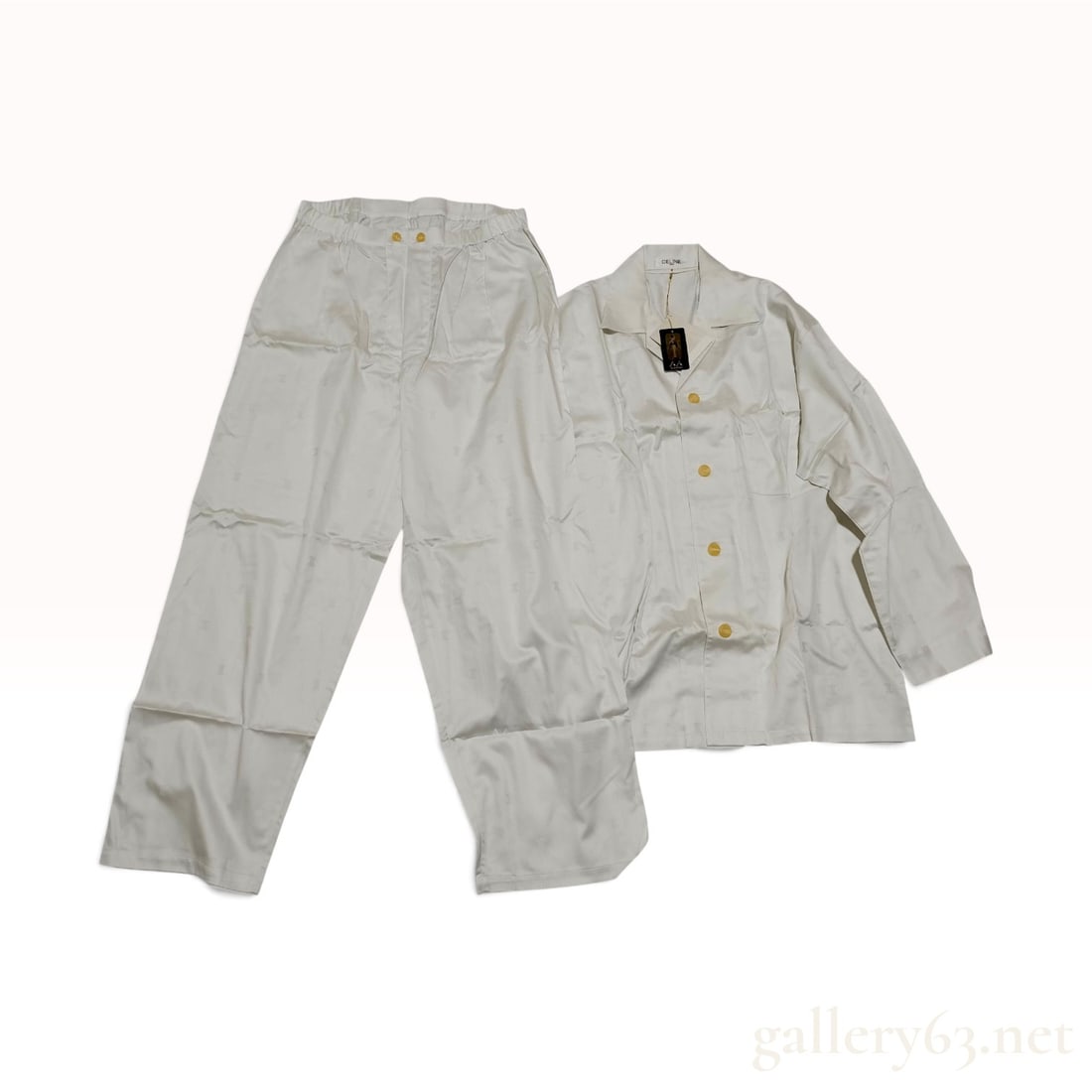 NWT Celine Blazon Jacquard Off-White Silk Two-Piece Pajama Set Size Large with Tags: This Celine two-piece lounge set is crafted from off-white silk featuring a tonal jacquard weave of the signature Blazon logo throughout. The ensemble consists of a long-sleeved shirt and matching tro