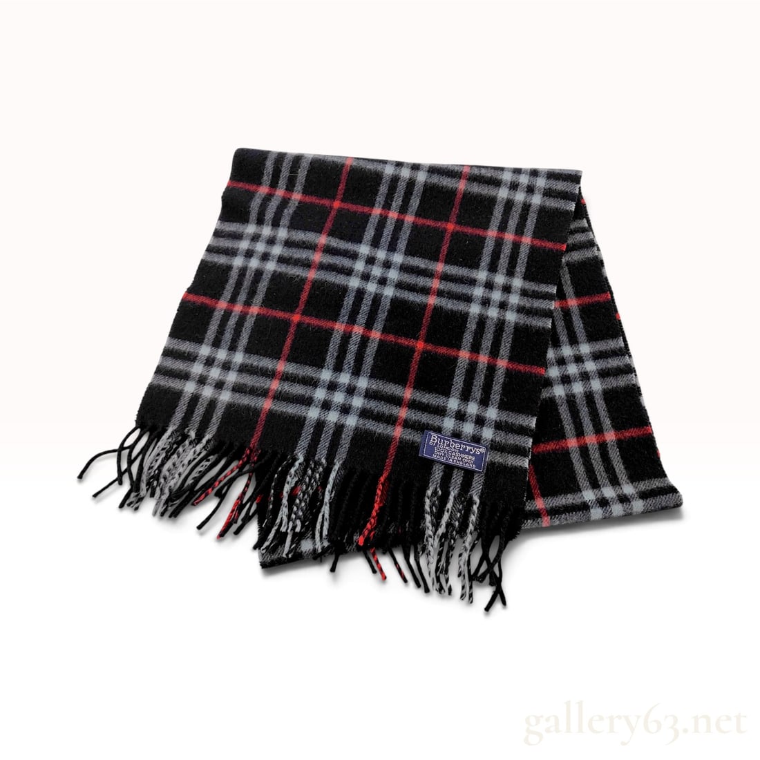 Vintage Burberrys Classic Check Black Cashmere Scarf 144cm: This Burberrys scarf is crafted from 100% cashmere in a classic check pattern. The design features a black ground with intersecting gray and red stripes, typical of the house's signature aesthetic. It