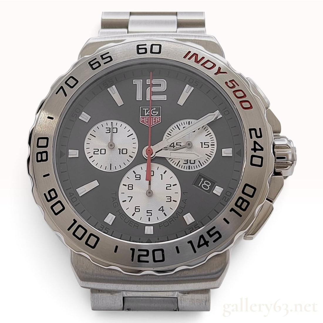 Tag Heuer Formula 1 Indy 500 Special Edition Stainless Steel Men's Wristwatch with Warranty Card: This TAG Heuer Formula 1 Indy 500 Special Edition chronograph wristwatch is crafted from brushed stainless steel. The 41.5mm case houses an anthracite sunray dial featuring three silver snailed subdia