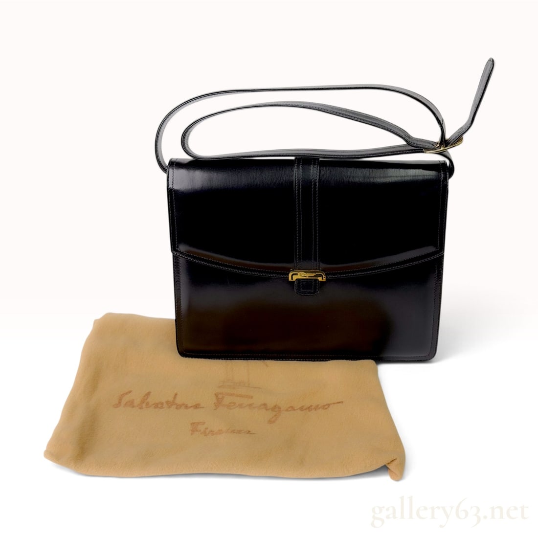 Vintage Salvatore Ferragamo Black Box Calf Leather Shoulder Bag with Dust Bag: This Salvatore Ferragamo shoulder bag is crafted from smooth black box calf leather in a structured rectangular silhouette. The design features a single adjustable leather shoulder strap and a front f