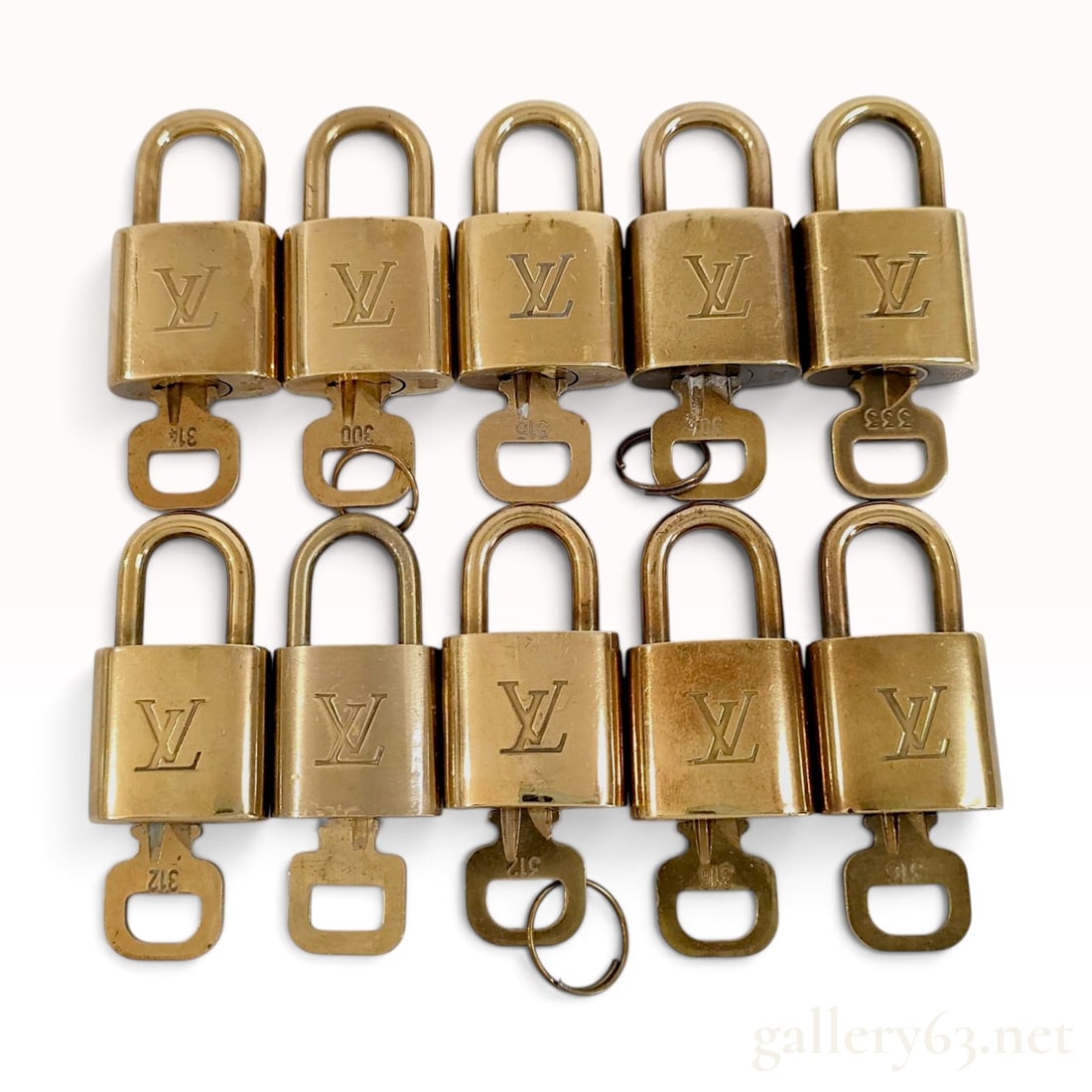 A Collection of Ten Louis Vuitton Brass Toned Handbag Padlocks and Keys: This collection of ten Louis Vuitton handbag padlocks is crafted from brass-toned metal, each accompanied by a matching key. The front face of each padlock features an embossed interlocking LV monogra