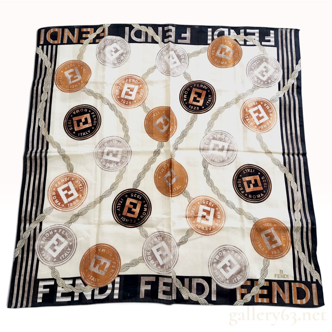 Vintage Fendi Medallion Logo Cream and Brown Silk Scarf 66 cm: This Fendi silk scarf is crafted from a cream-colored silk with a vertical jacquard weave that repeats the FENDI name. The central field is decorated with circular medallions in black, bronze, and sil