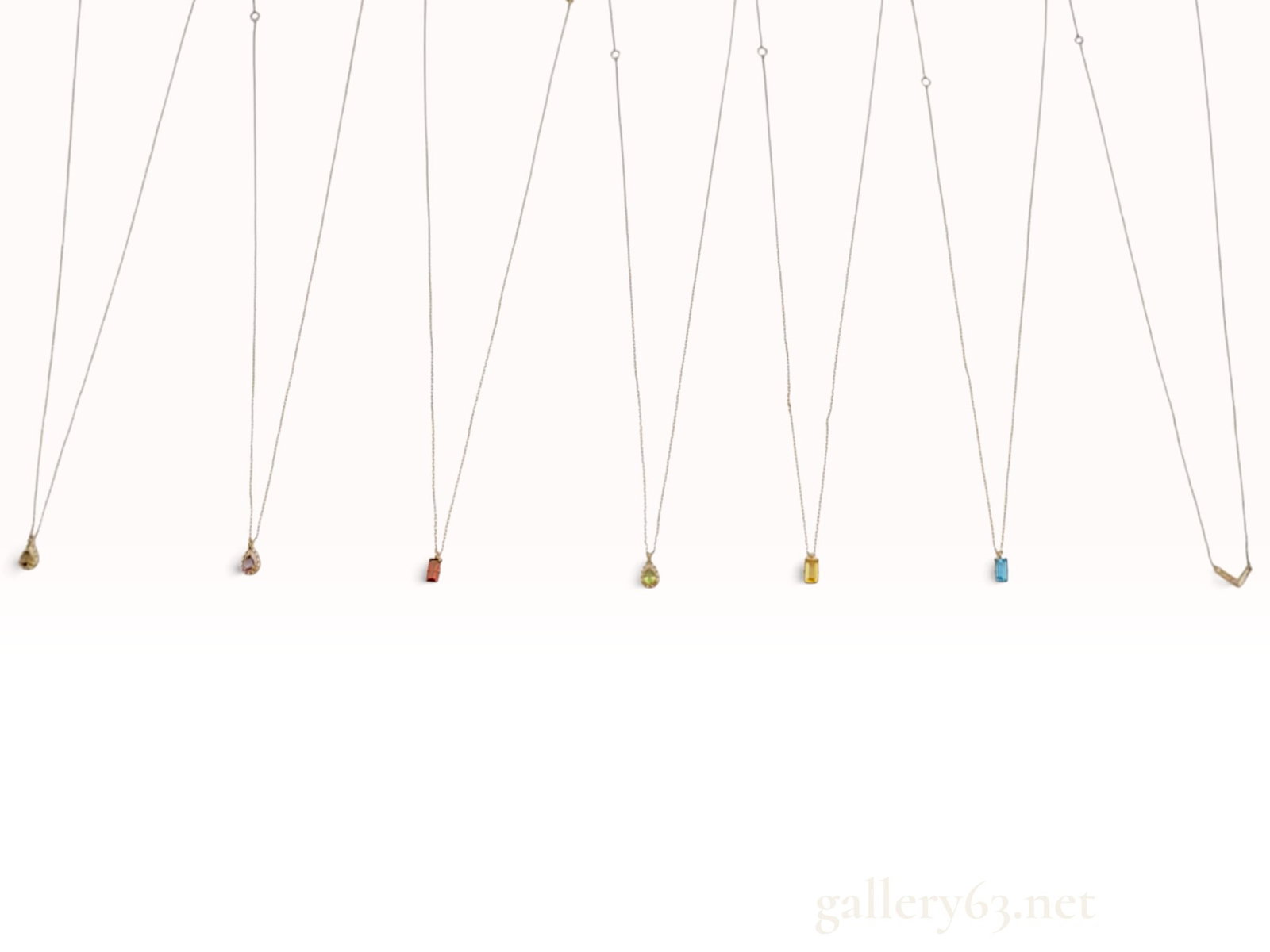 Seven 10K Yellow Gold and Multi-Gemstone Pendant Necklaces: An assortment of seven fine pendant necklaces crafted in 10 karat yellow gold. The collection features three necklaces with pear-shaped faceted gemstones: one smoky quartz, one light purple amethyst, 