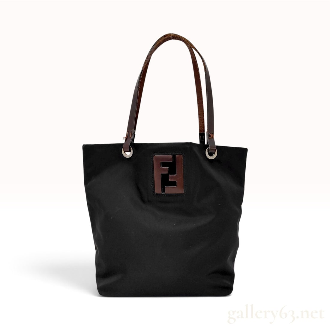 Vintage Fendi Zucca FF Black Nylon and Leather Tote Bag: This Fendi tote bag is crafted from black nylon with dark brown leather handles and a matching leather base. The front of the bag is decorated with a large, square dark brown leather patch featuring t
