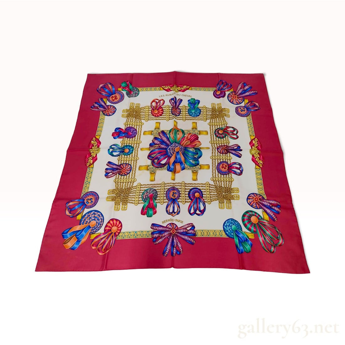 Hermes Les Rubans du Cheval Red Silk Carre 90: This Hermes silk carre 90 in the Les Rubans du Cheval pattern was designed by artist Joachim Metz. The equestrian-themed composition features a central floral ribbon cluster surrounded by various colo