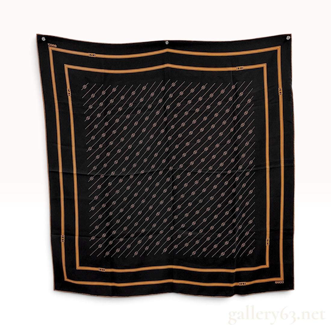 Vintage Gucci Interlocking GG Black Silk Carre 90: This Gucci silk carre 90 is crafted from black silk and features a diagonal repeating pattern of gold-toned interlocking GG logos and parallel lines. The center design is framed by multiple borders in
