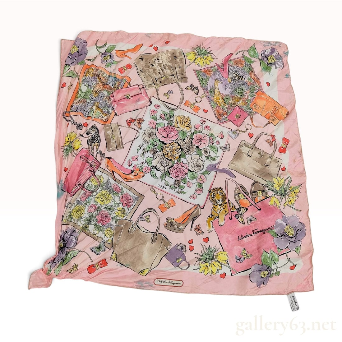 Salvatore Ferragamo Accessories and Floral Motif Pink Silk Scarf 66cm: This Salvatore Ferragamo silk scarf features a collage design of illustrated brand accessories, including various handbags, high-heeled shoes, and belts. The composition is embellished with floral spr