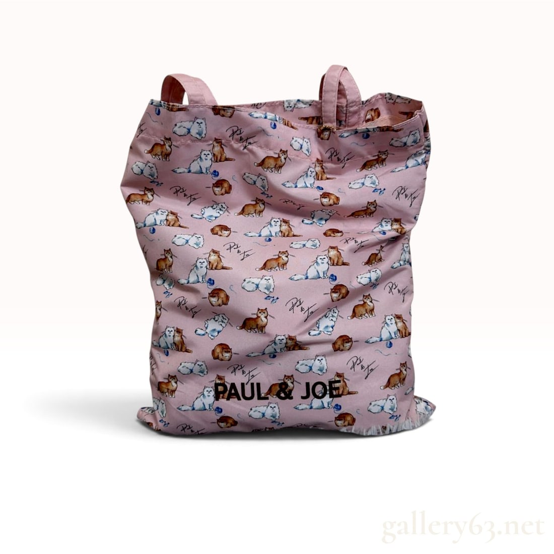 Paul & Joe Cat Print Pink Foldable Tote Bag and Pouch Set: This Paul & Joe accessory set consists of a foldable tote bag and a matching zippered pouch, both crafted from a lightweight pink synthetic fabric with a smooth finish. The exterior of both pieces fea