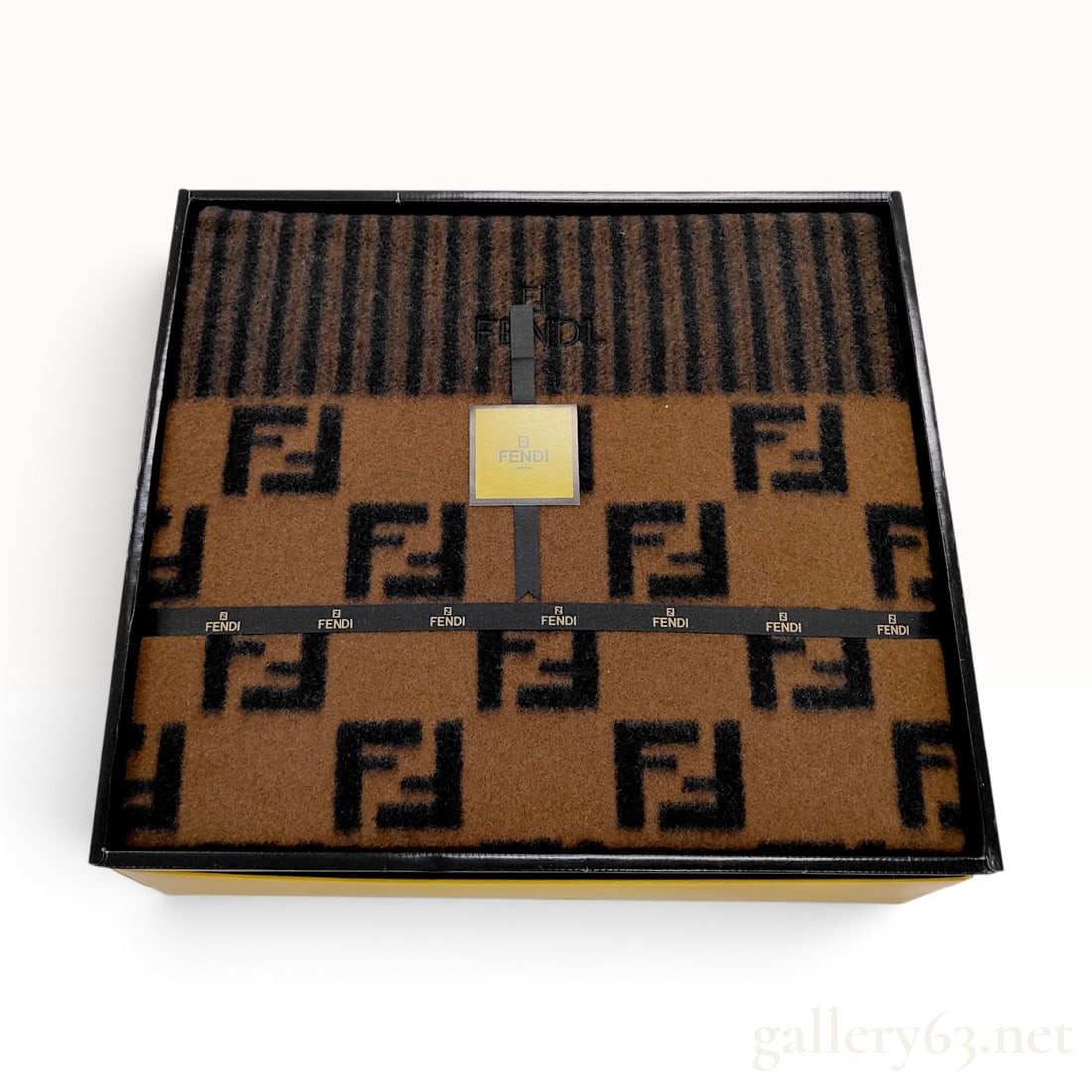 Fendi Zucca Monogram Tobacco Brown Pure New Wool Blanket with Box: A Fendi wool blanket crafted from pure new wool in a reversible tobacco brown and black Zucca monogram pattern. The design incorporates a section of tonal vertical stripes at one end, featuring a tona