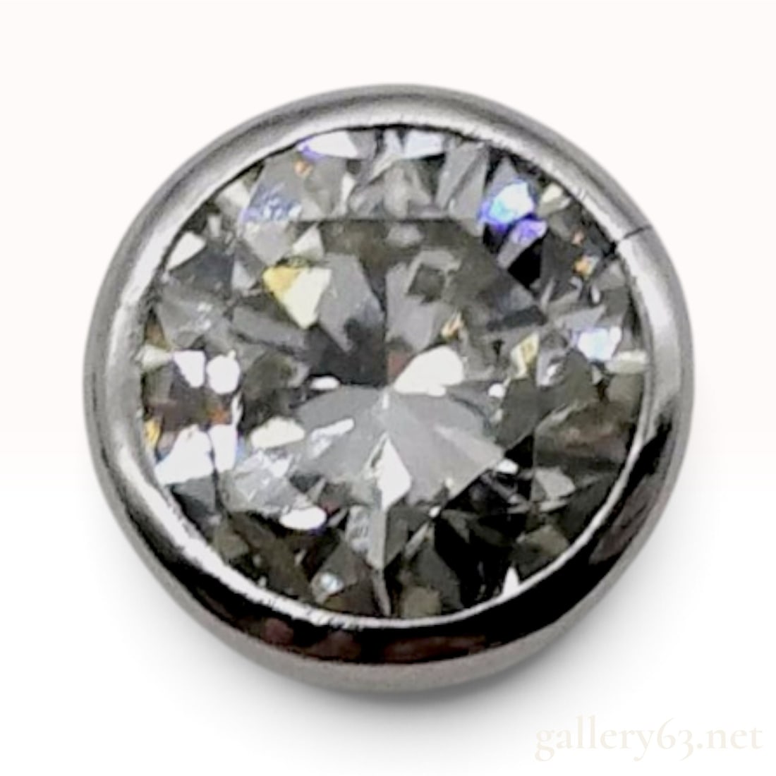 Platinum 0.76ct Natural Diamond Bezel Set Stud Earring: This platinum stud earring is crafted with a bezel-set round brilliant-cut natural diamond. The stone has an indicated weight of 0.76ct and is housed within a circular platinum frame. The reverse of t