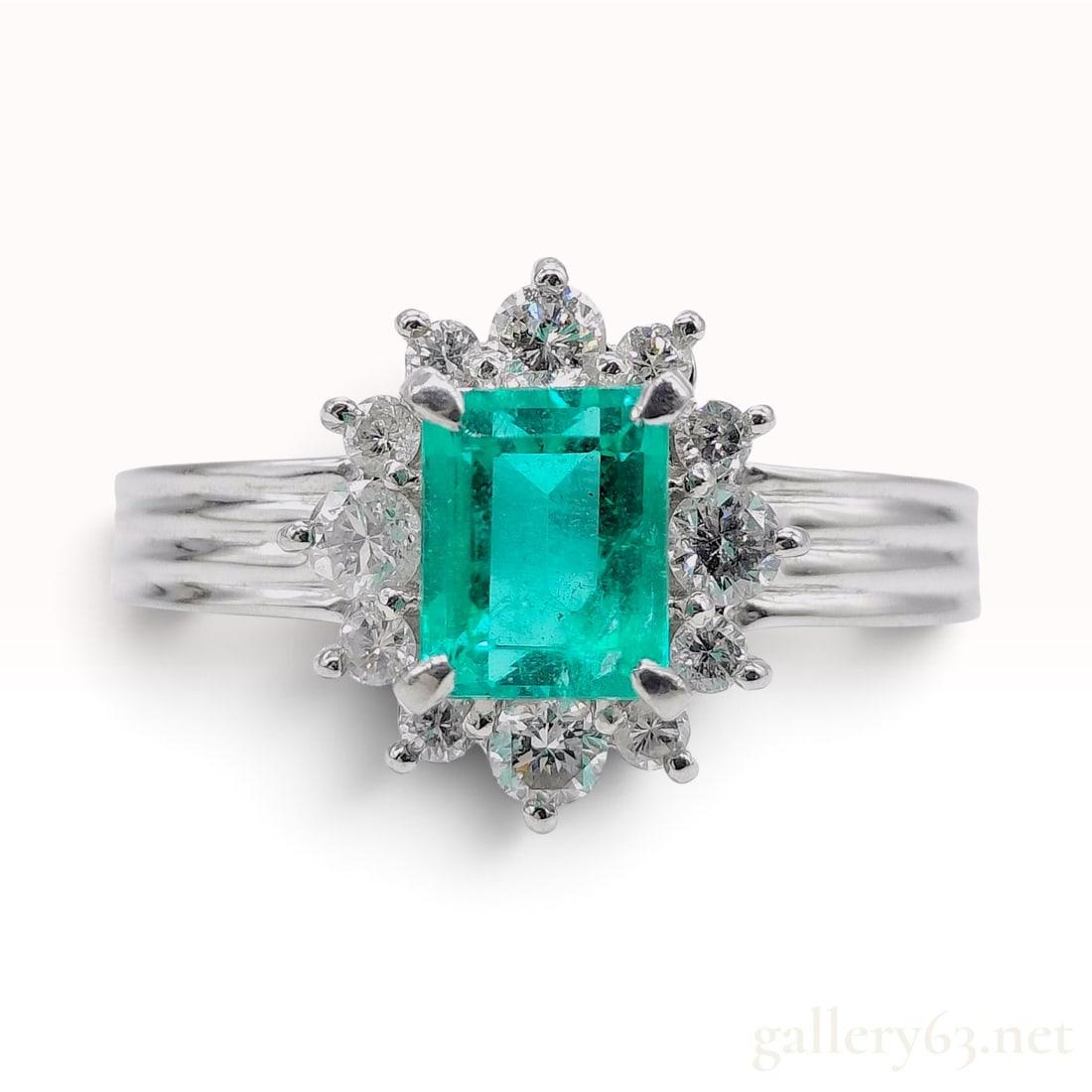 Pt850 Platinum 0.84ct Emerald and 0.34ctw Natural Diamond Cluster Ring: This platinum cocktail ring centers a rectangular emerald-cut natural emerald weighing 0.84ct. The emerald exhibits a vibrant green saturation with visible natural internal inclusions. The primary sto