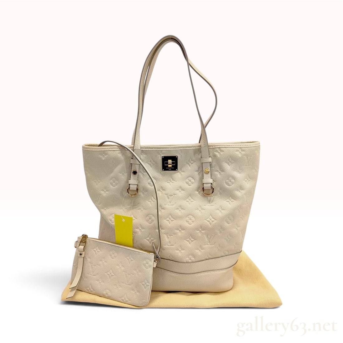 Louis Vuitton Citadine PM Neige Monogram Empreinte Leather Tote Bag with Dust Bag: This Louis Vuitton Citadine PM tote bag is crafted from Neige ivory-colored Monogram Empreinte embossed calfskin leather. The tall tote silhouette is accented with grey edge glazing and polished gold-