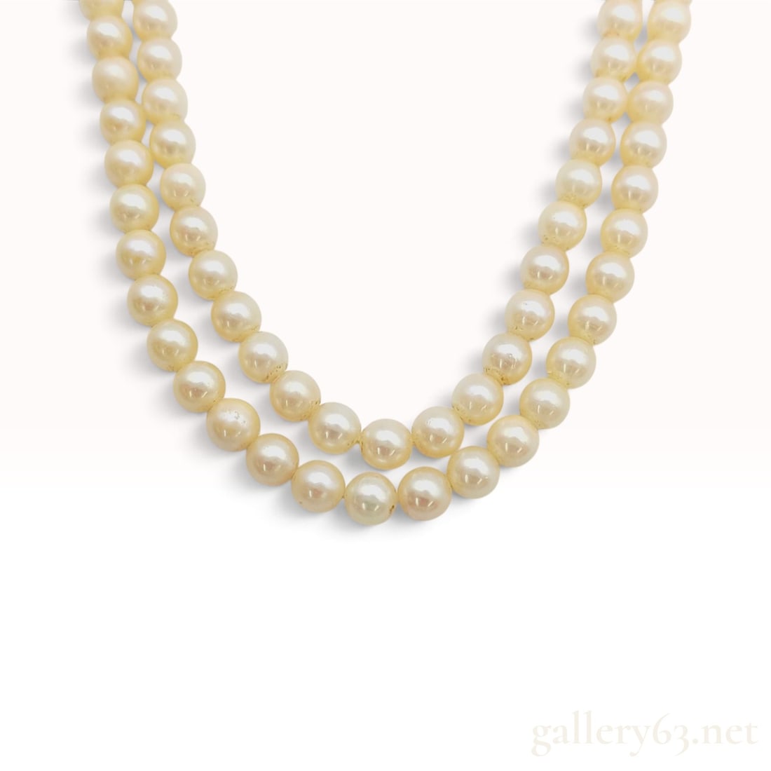 Double-Strand Cream Cultured Pearl 16.5 Inch Necklace: A double-strand necklace composed of cream-colored cultured pearls. The pearls measure approximately 6.5mm to 7mm in diameter and are individually hand-knotted on a white cord. Each strand consists of