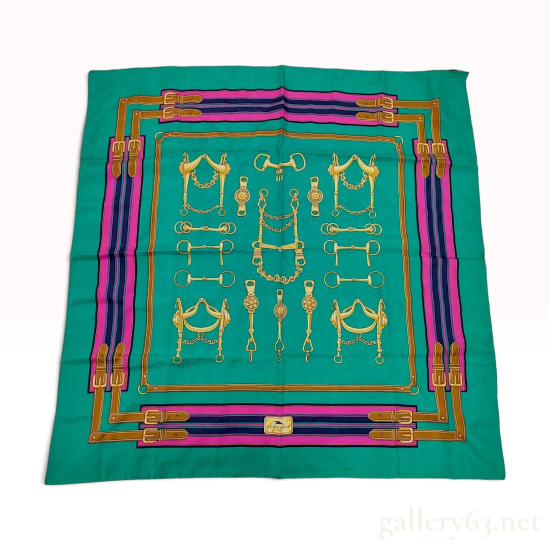 Longchamp Equestrian Hardware Motif Green Silk Scarf 90 cm: This Longchamp silk scarf is crafted from fine Italian silk in a vibrant green colorway. The central field features a symmetrical arrangement of gold-toned equestrian hardware, including snaffle and c