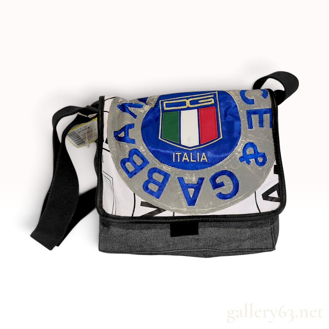 Vintage Dolce & Gabbana Italia Sport Grey Canvas Messenger Bag with Retail Tag: This Dolce & Gabbana messenger bag is crafted from grey cotton canvas and white printed canvas. The front flap features a large central patch with an interlocking DG logo in gold embroidery above an I