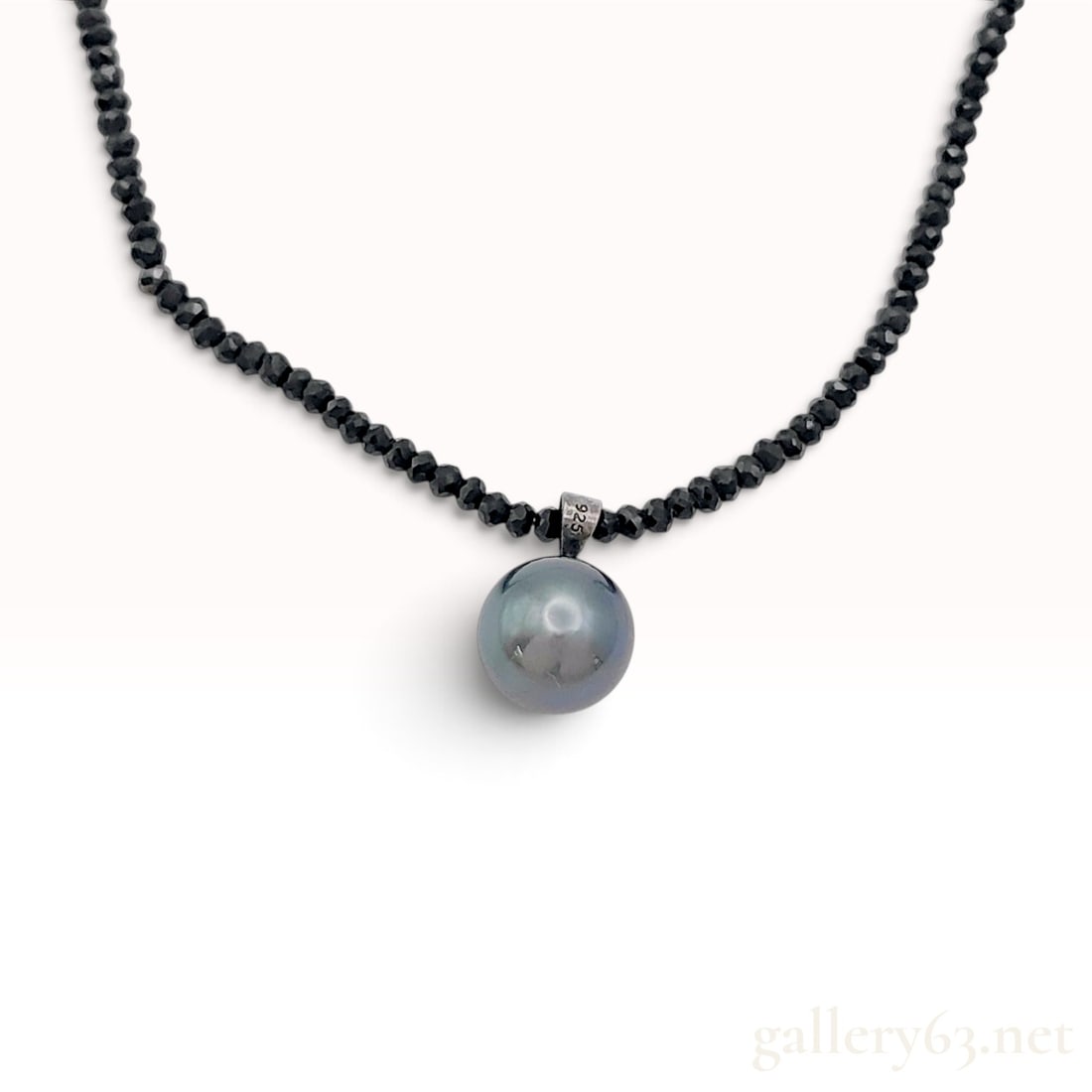 Sterling Silver 10mm Tahitian Pearl and Black Spinel Bead Pendant Necklace: This sterling silver pendant necklace features a round dark grey Tahitian pearl measuring 10mm in diameter, exhibiting a high luster and subtle iridescent overtones. The pendant is suspended by a tape