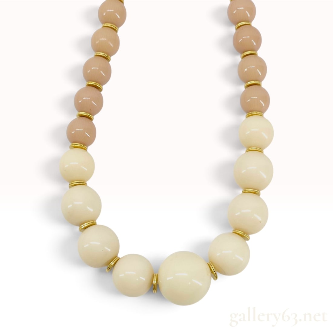 Vintage Yves Saint Laurent Graduated Cream and Tan Resin Bead Necklace: This Yves Saint Laurent collar necklace is crafted with graduated molded resin beads in cream and tan colors. The center of the necklace features a sequence of cream beads that graduate in size, with 