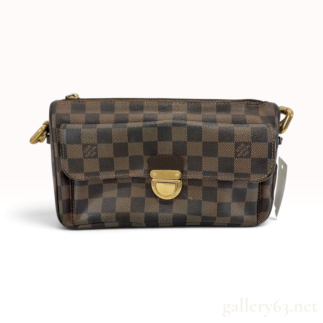 Louis Vuitton Damier Ebene Ravello PM Shoulder Bag: This Louis Vuitton Ravello PM shoulder bag is crafted from signature Damier Ebene coated canvas with dark brown leather trim and piping. The compact design features a front exterior pocket secured by 