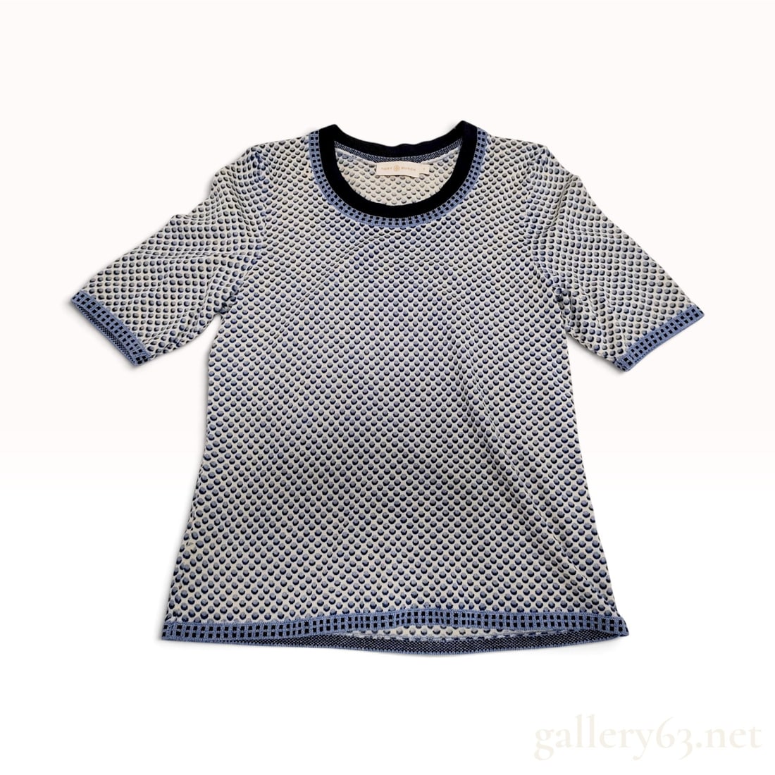 Tory Burch Textured Dot Blue and Cream 100% Merino Wool Short Sleeve Top Small: This Tory Burch short-sleeved knit top is crafted from 100% merino wool in a textured honeycomb pattern. The cream ground features an all-over blue and navy dot motif, complemented by a solid dark nav