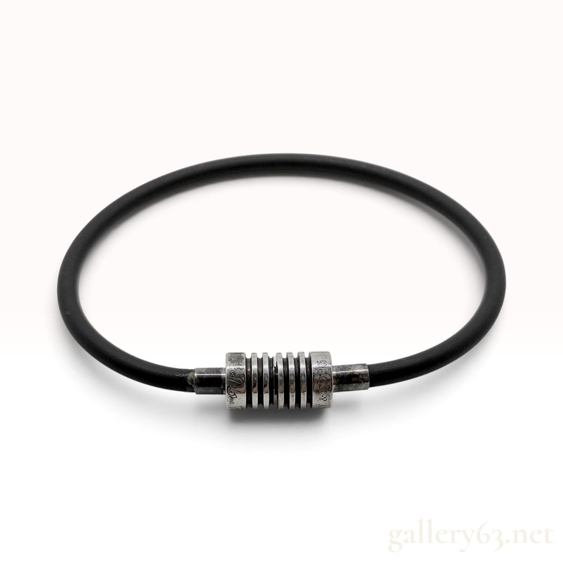 Vintage Tiffany & Co. Paloma Picasso Black Rubber and Sterling Silver Groove Bracelet: This Tiffany & Co. bracelet designed by Paloma Picasso is crafted from flexible black rubber with sterling silver components. The design features a black rubber cord terminated with sterling silver fe