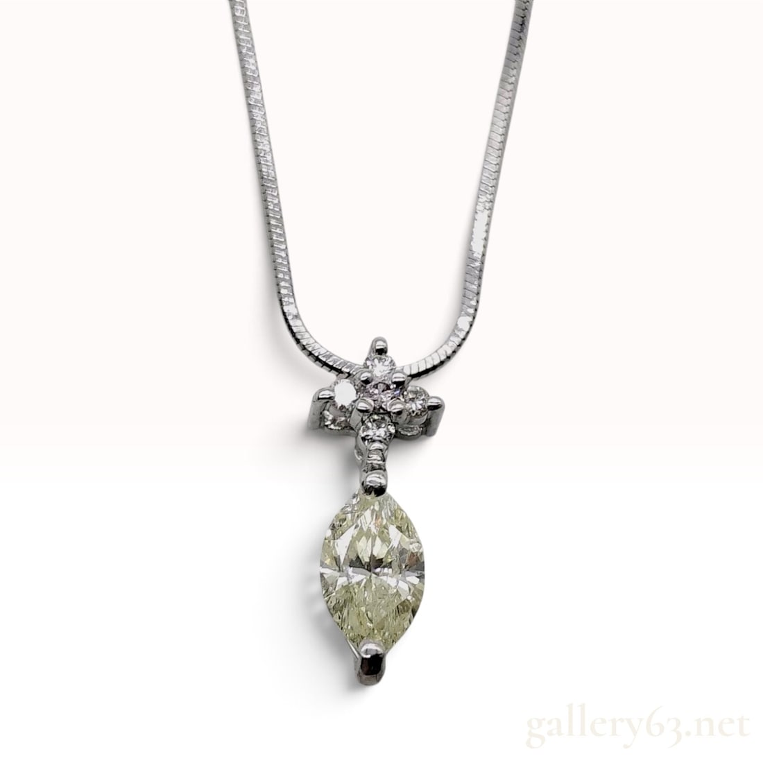 Platinum 0.358ct and 0.09ctw Natural Diamond Marquise Drop Pendant Necklace: This platinum and natural diamond pendant necklace is crafted with a Pt850 round snake chain and a Pt900 drop pendant. The pendant features a central 0.358ct marquise-cut natural diamond with a distin