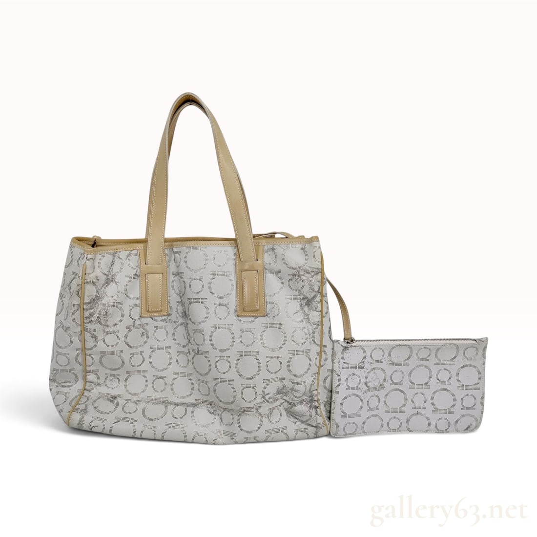 A Vintage White Coated Canvas and Tan Leather Logo Print Tote Bag with Pouch: This tote bag is crafted from white textured coated canvas featuring an all-over repeating pattern of silver-tone dotted circular monograms. The bag is constructed with tan leather trim along the top 