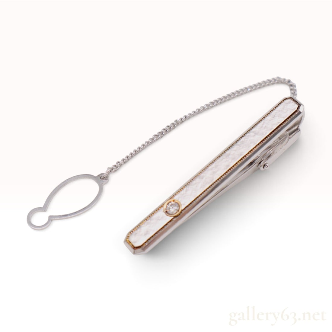 BlueStar 18K and Sterling Silver 0.08ct Natural Diamond Tie Clip: This BlueStar tie clip is crafted from sterling silver featuring a textured white mother-of-pearl inlay along the face. Centered within the inlay is a single round brilliant-cut 0.08ct natural diamond